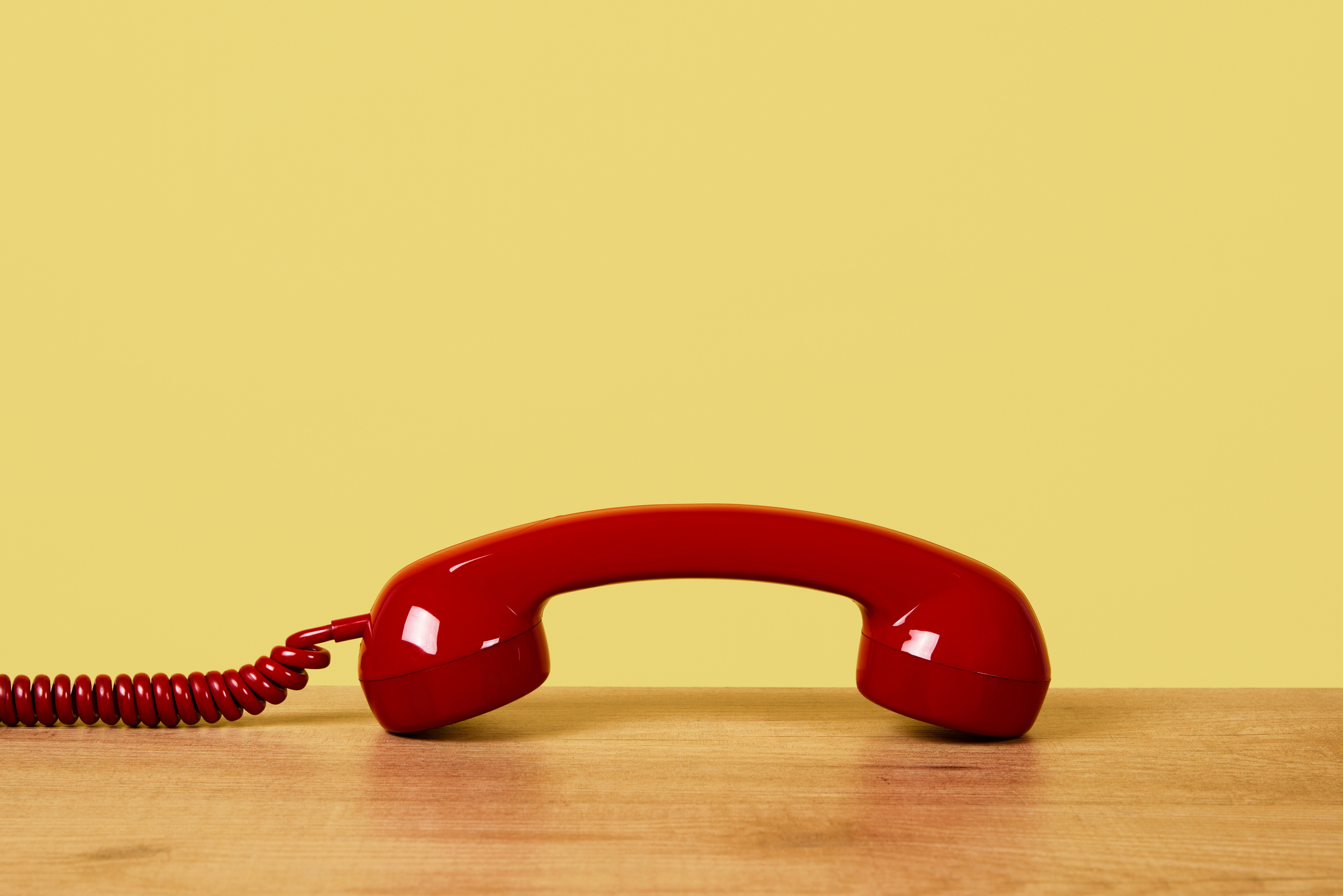 Red Telephone on Wooden Table